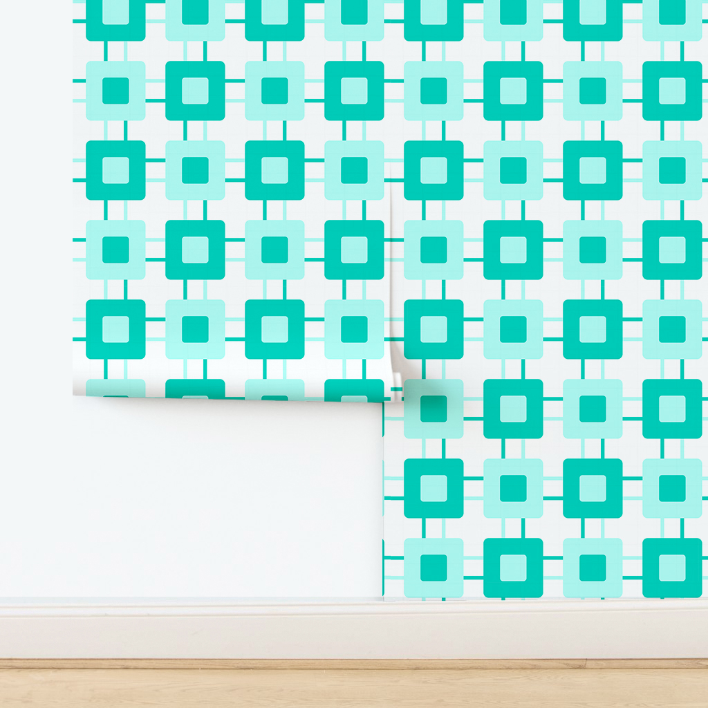 The artwork features a repeating geometric pattern of symmetrical shapes resembling elongated, curved diamonds or petals in various shades of blue and green. Each shape is split vertically with one half filled with a light blue and the other half filled with green or darker blue. The background is a light, almost pastel blue, which provides a soft yet vibrant backdrop. One of the blue shapes near the upper left contains a white starburst element, adding a focal point of brightness to the composition. The overall design conveys a modern, mid-century aesthetic with clean lines and harmonious color contrasts.